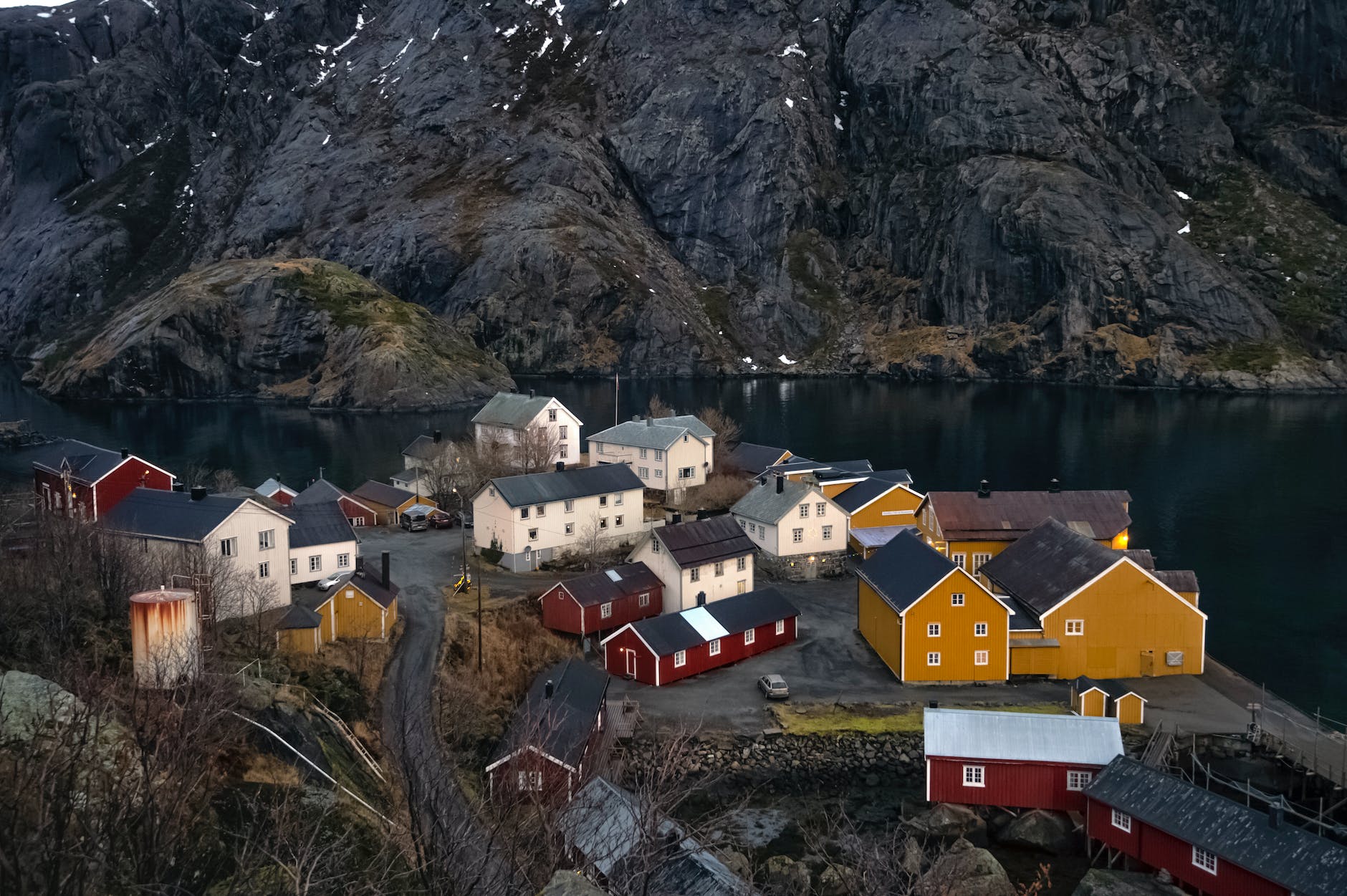 colorful houses near water in mountain village